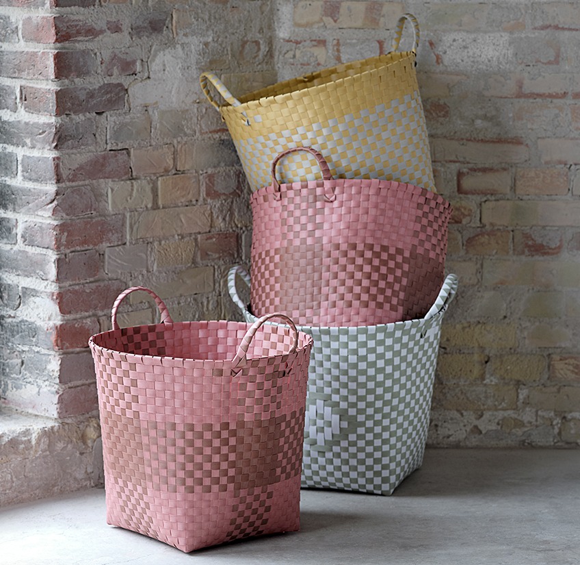 Four baskets in different colours stacked 